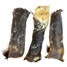 Three pieces of dried natural cow hide on a white background